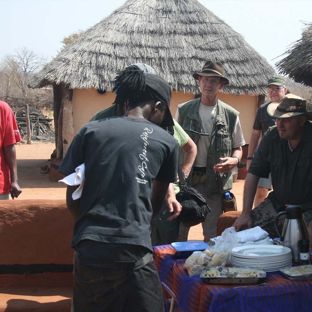 Enjoying lunch during a Cultural village tour in Victoria Falls Village of Monde